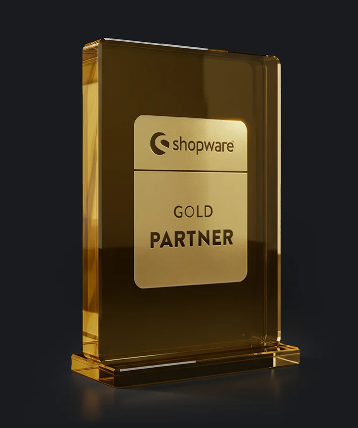 Statuetka Shopware Gold Partner w formie złotego szklanego bloku na ciemnym tle